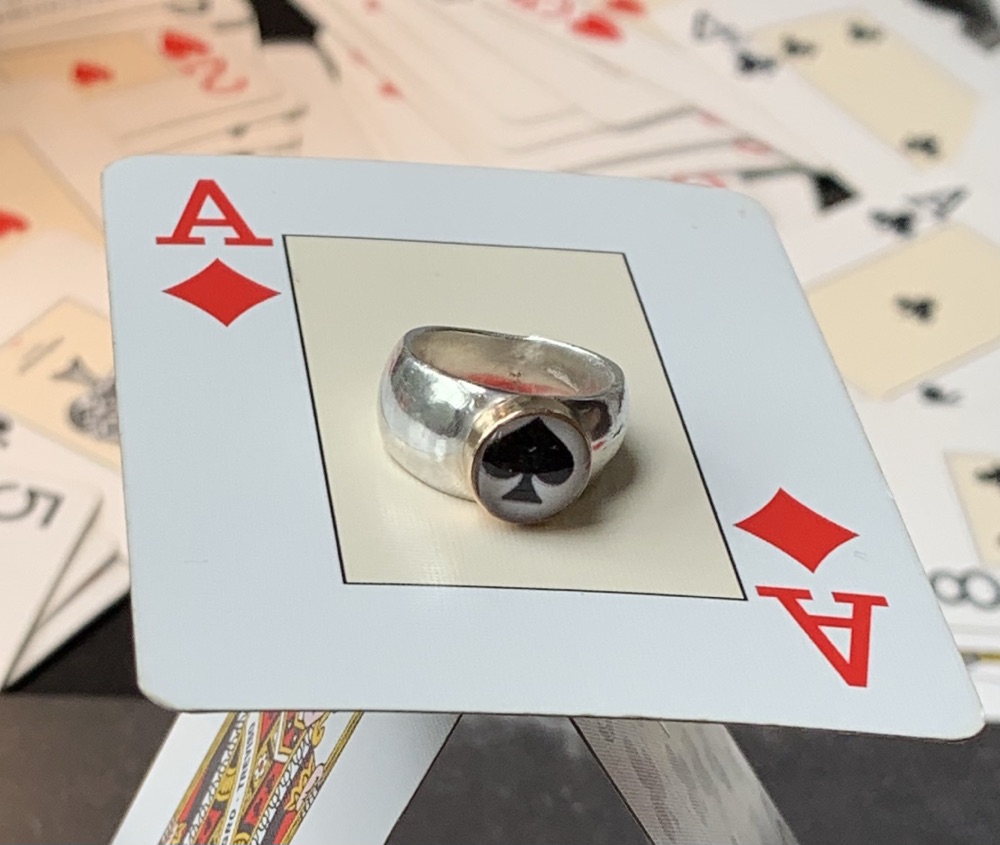 Zilveren ring met aas in gouden kast